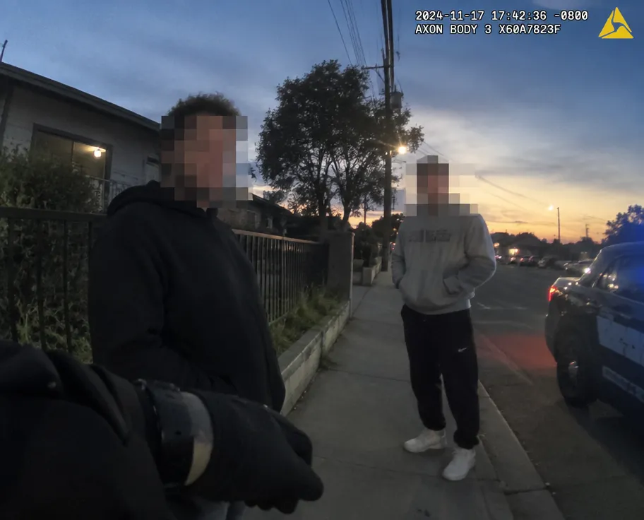 Bodycam street scene with bystander faces pixelated