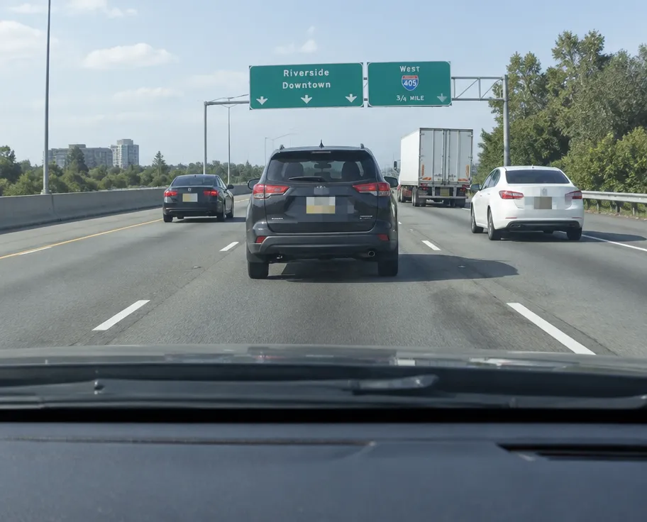 Dashcam highway scene with license plates pixelated
